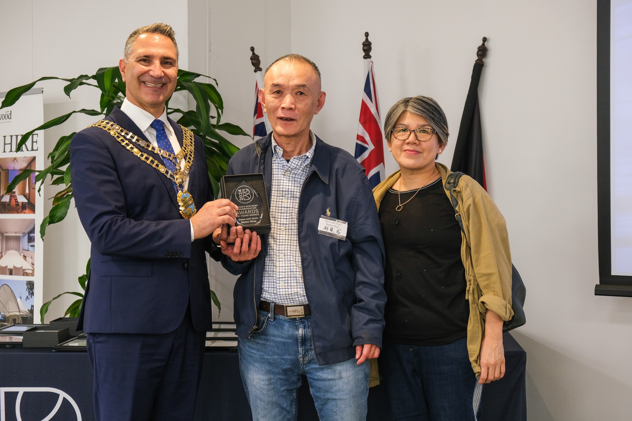 image of owners accepting award from the mayor