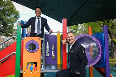 Mayor John Faker and Jason Yat-Sen Li MP enjoy the new play equipment