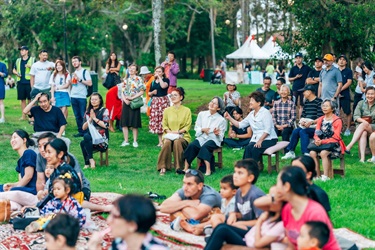 people sitting and standing on grass