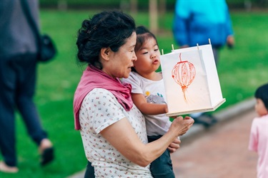 woman and child holding lantern