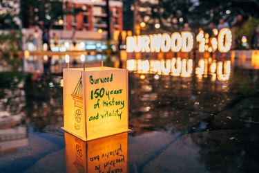 lantern with 'Burwood 150 years of history and vitality' written on it floating on pond