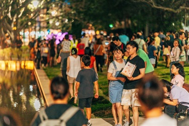 couple holding a lantern surrounded by a crowd