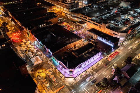 An aerial view of Burwood Road at night lit up during a street festival