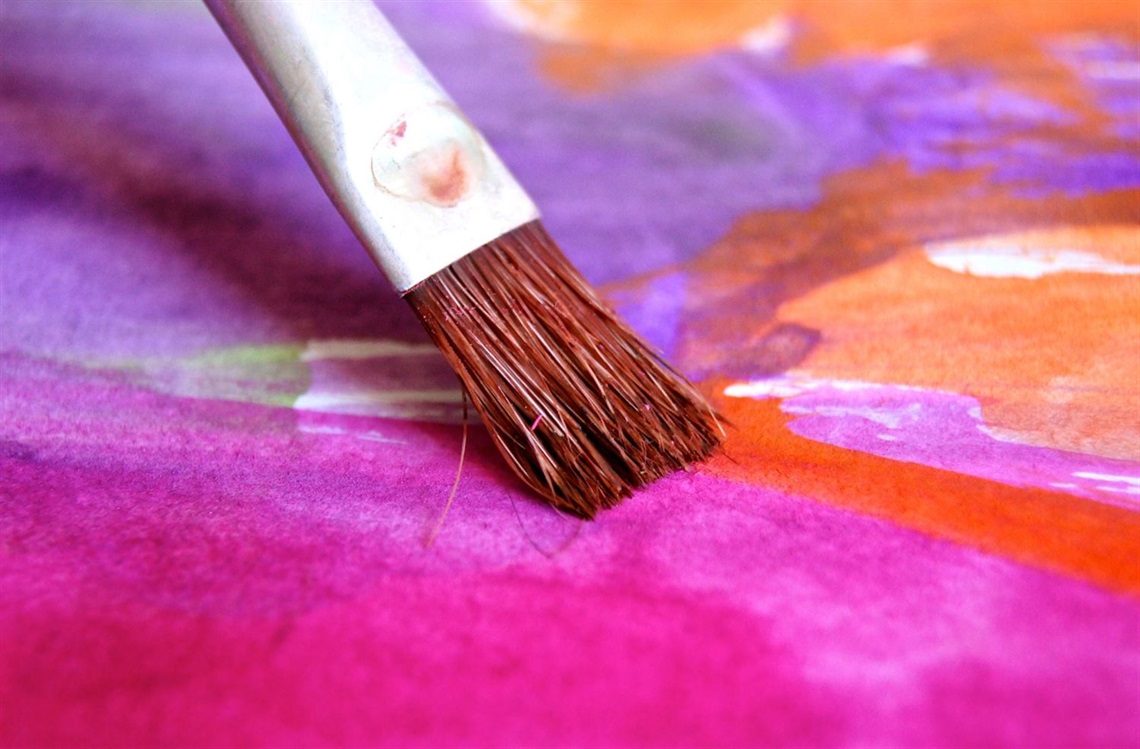 Paintbrush with colourful paint