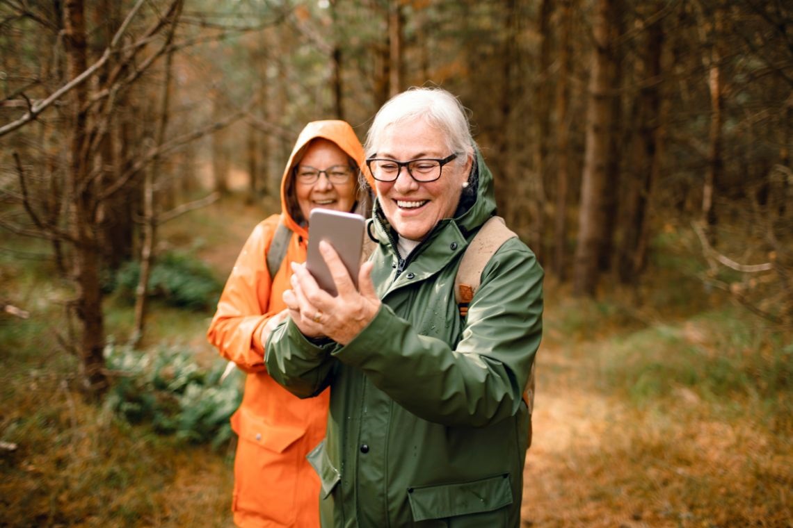 Pictue of seniors walking with  mobile phone