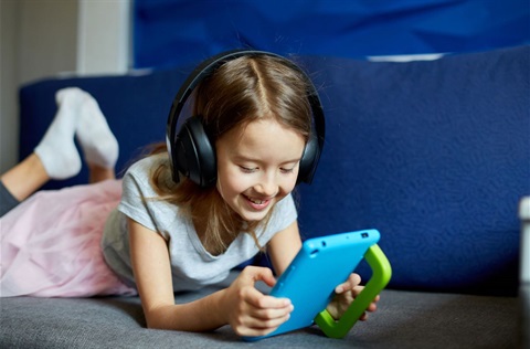 Photo of girl smiling using a tablet device