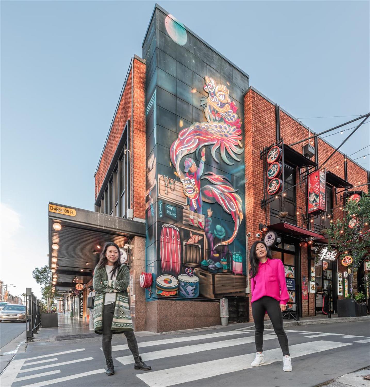 artists Christina Huynh and Sophi Odlinga next to a public art mural in Burwood