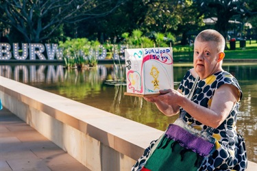 person holding lantern next to pond