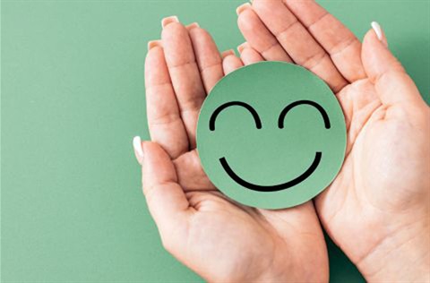 Picture of a smile drawn on a circle in hands